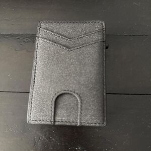 Black faux leather wallet with textured surface